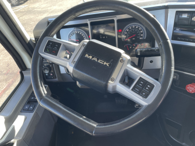 Steering wheel view inside a 2020 Mack AN64T truck cab showing Mack logo, instrument cluster, and steering wheel controls.