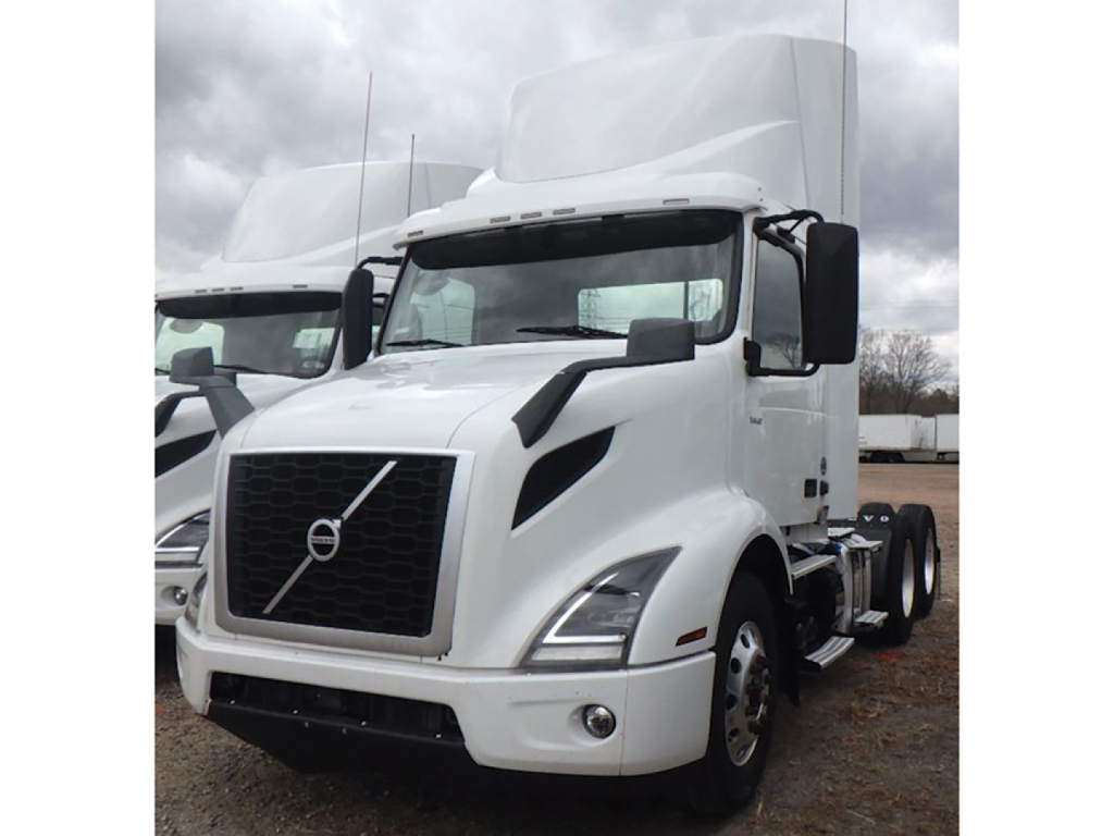 Volvo VNR 300 truck cab and front view showing grille and headlamps.