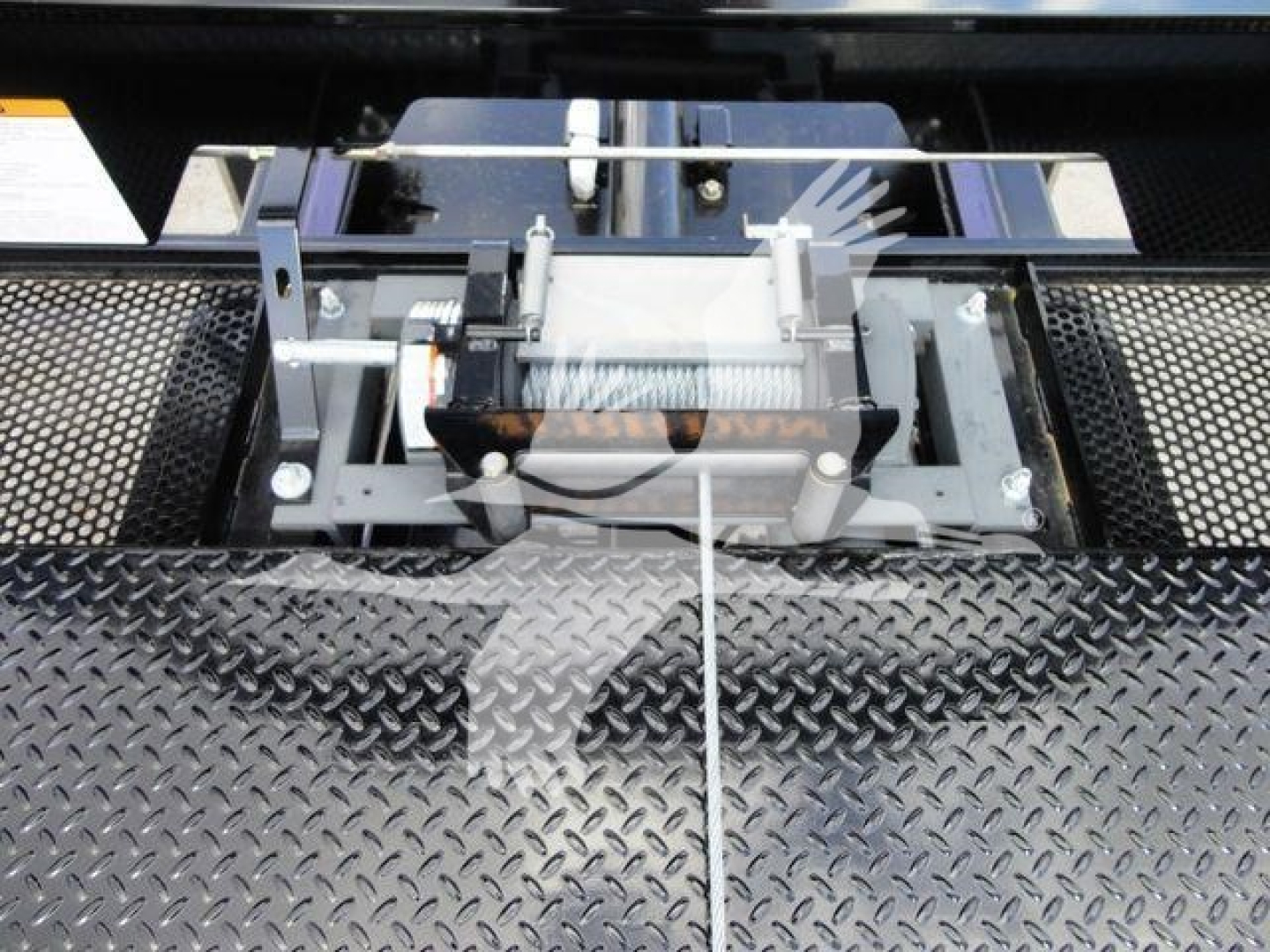 Trucks equipment mount showing a wheel-lift or hoist assembly on a diamond plate surface.