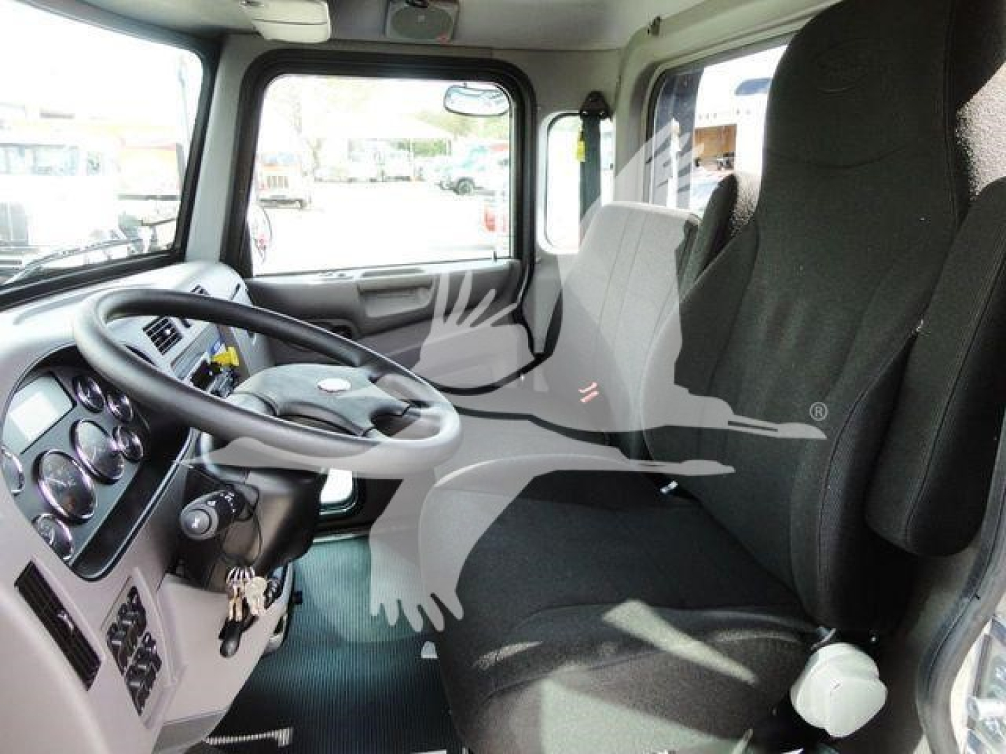 Peterbilt 337 cab interior showing steering wheel, dashboard gauges, and front seats.