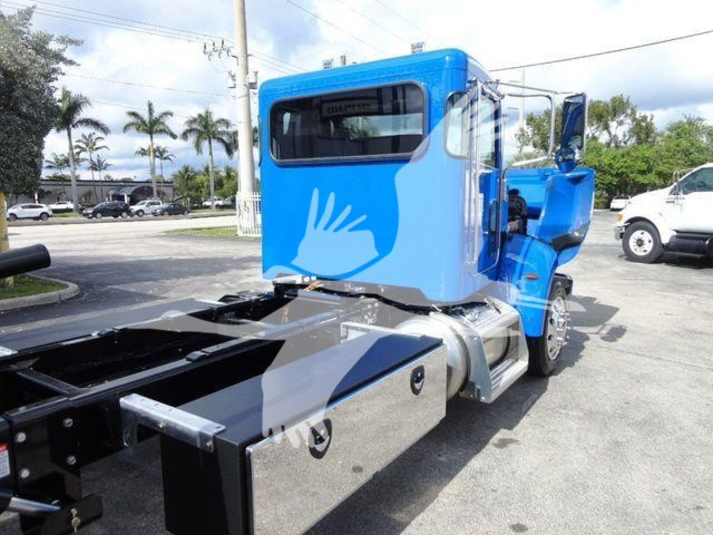 Blue Peterbilt 337 rollback truck cab and chassis side view showing rear frame and fuel tank