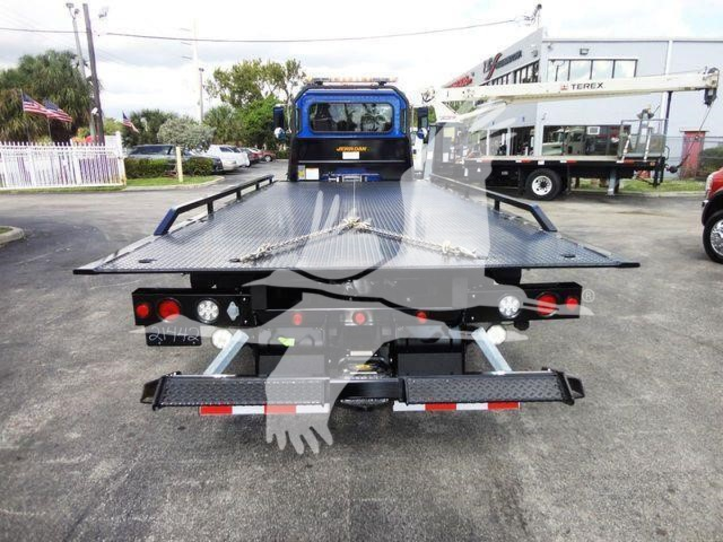 Peterbilt 337 rollback truck rear view showing flatbed with ramps and towing equipment.