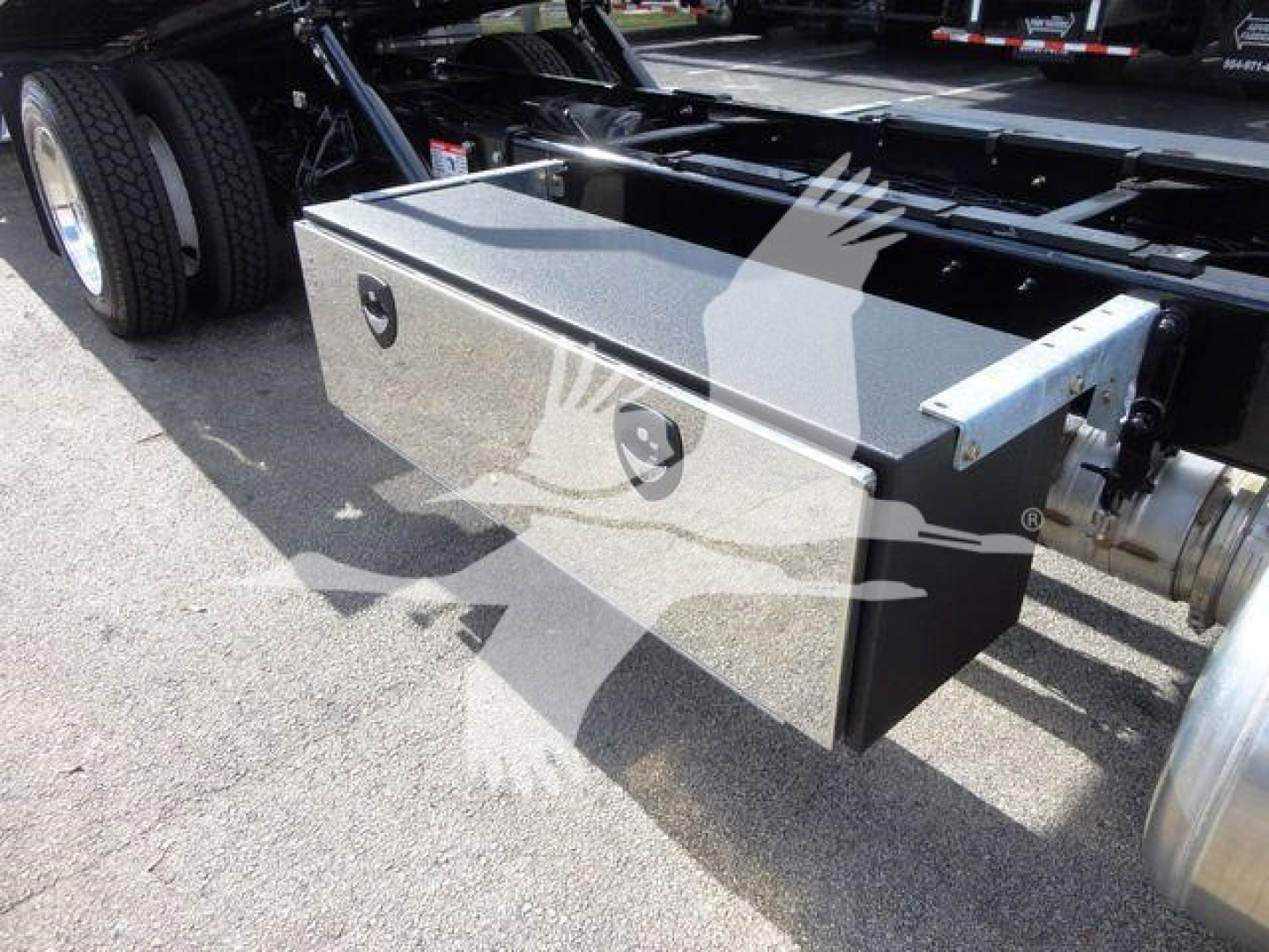 Peterbilt 337 rollback truck chassis side toolbox with diamond plate finish mounted under the cab; square metal toolbox with handle and lock.