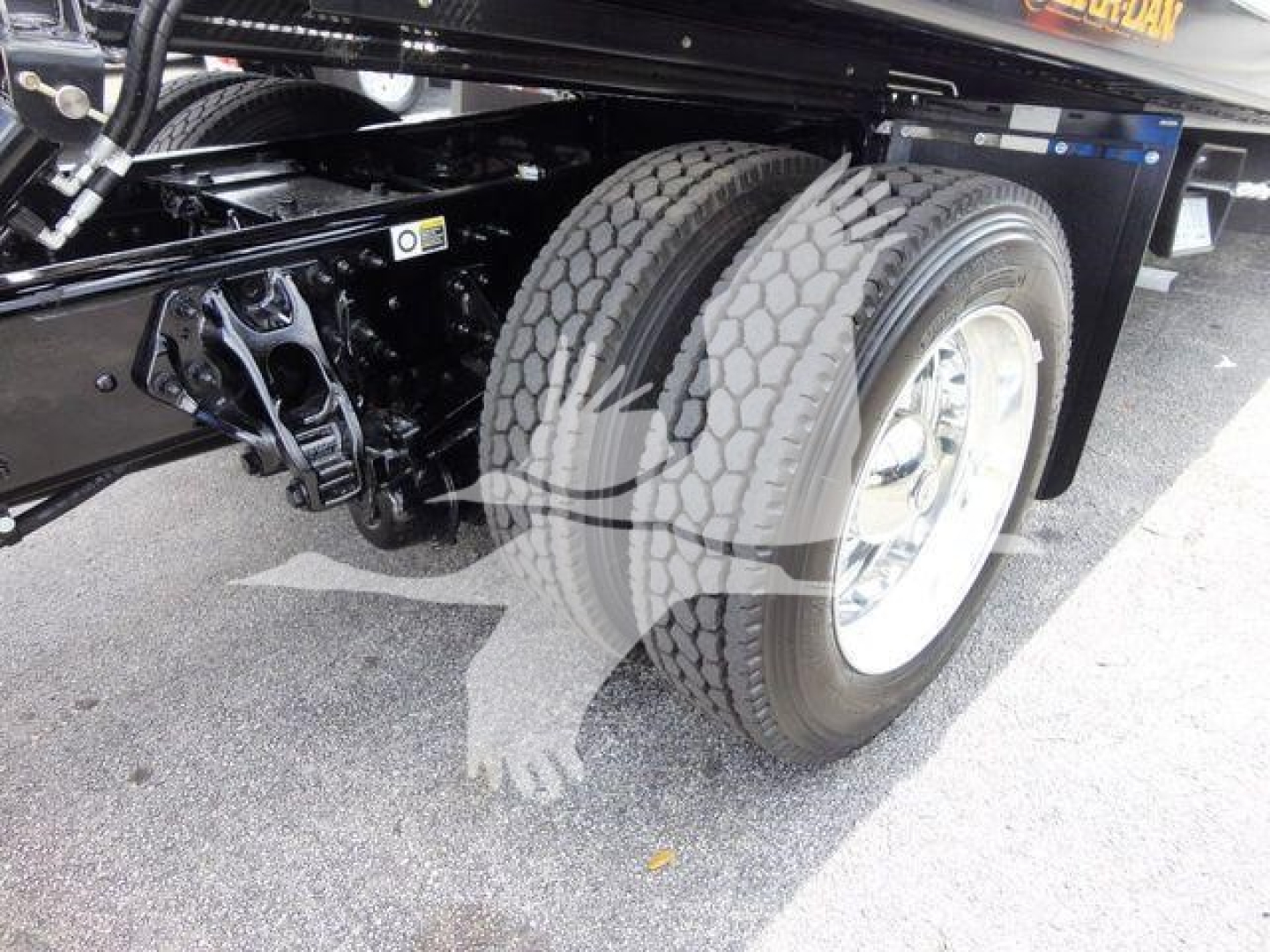 Peterbilt 337 truck rear dual wheels and suspension components in view showing dual rear tires and undercarriage