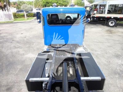 Truck cab shows blue sleeper with rollback chassis and black wheel wells; labelable components not visible.