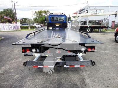 Peterbilt 337 rollback truck rear view showing flatbed with ramps and towing equipment.