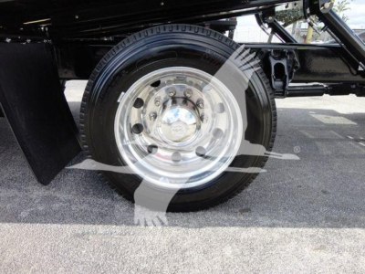 Peterbilt 337 rollback truck wheel and fender view with polished steel rim and black chassis.