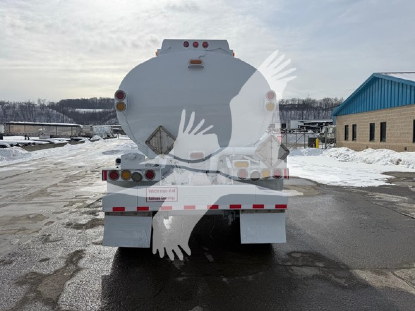 Rear view of 2014 Heil trough bottom Petro Tank trailer showing circular tank with rear lighting and reflective tape.