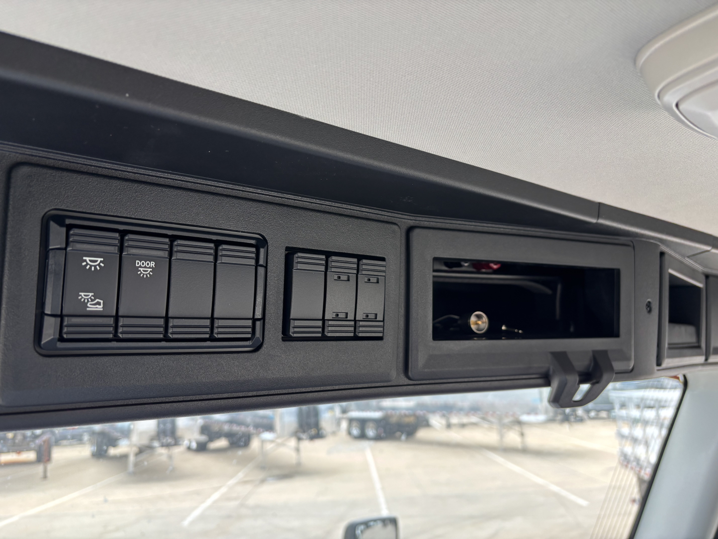 Mack AN64 cab interior showing control panel with switches and empty overhead storage compartment.