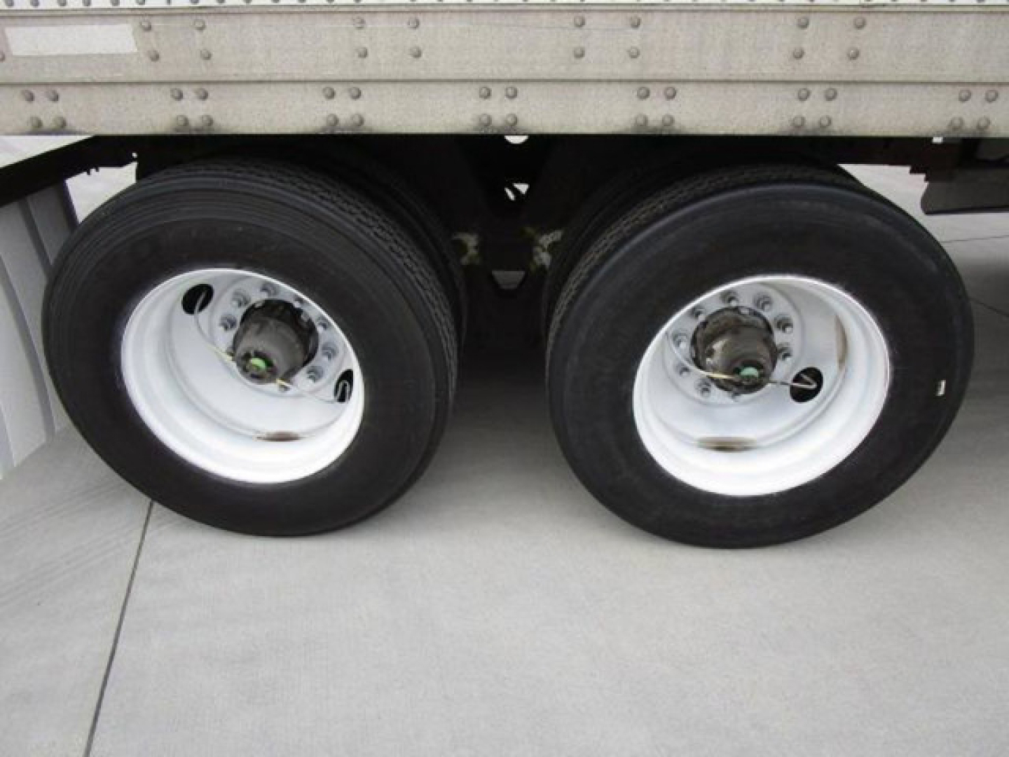 Dual trailer tires on a 2014 Stoughton Van showing wheels and suspension