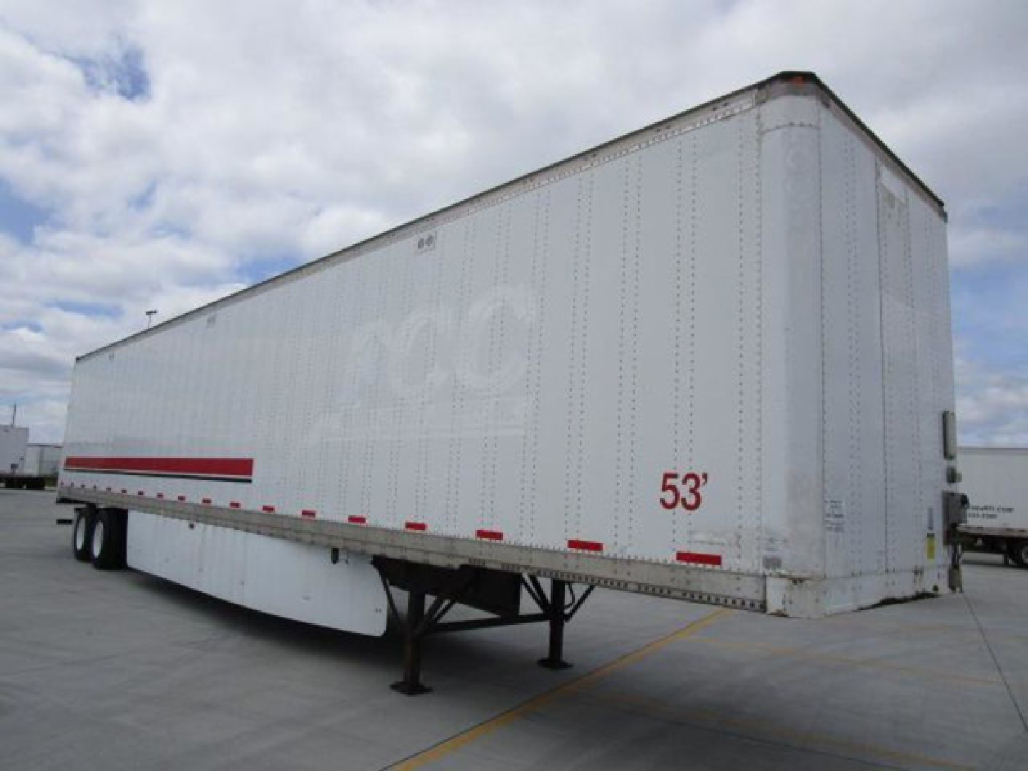 Trailer side view showing 53' Stoughton van trailer with white exterior and red reflective tape, dual rear axles, front landing gear visible.