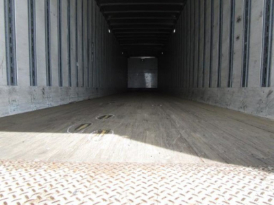 Flat interior of a 2014 Stoughton van trailer showing wooden floor, side metal walls, and rear door opening, empty cargo space.