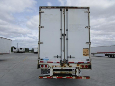 Rear view of a white 2014 Stoughton van trailer with double doors, rust on lower rear frame, red and white reflective tape, and several rear lights.