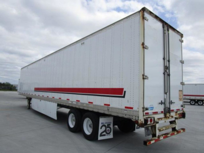 Trailer side view showing 2014 Stoughton van trailer with red and black stripe, tandem rear axles, doors closed, white exterior.