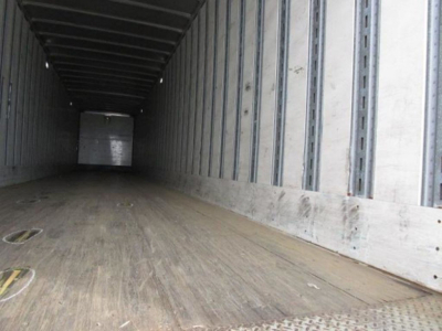 Trailer interior showing empty cargo area with wooden floor and metal sidewalls in a Stoughton van.