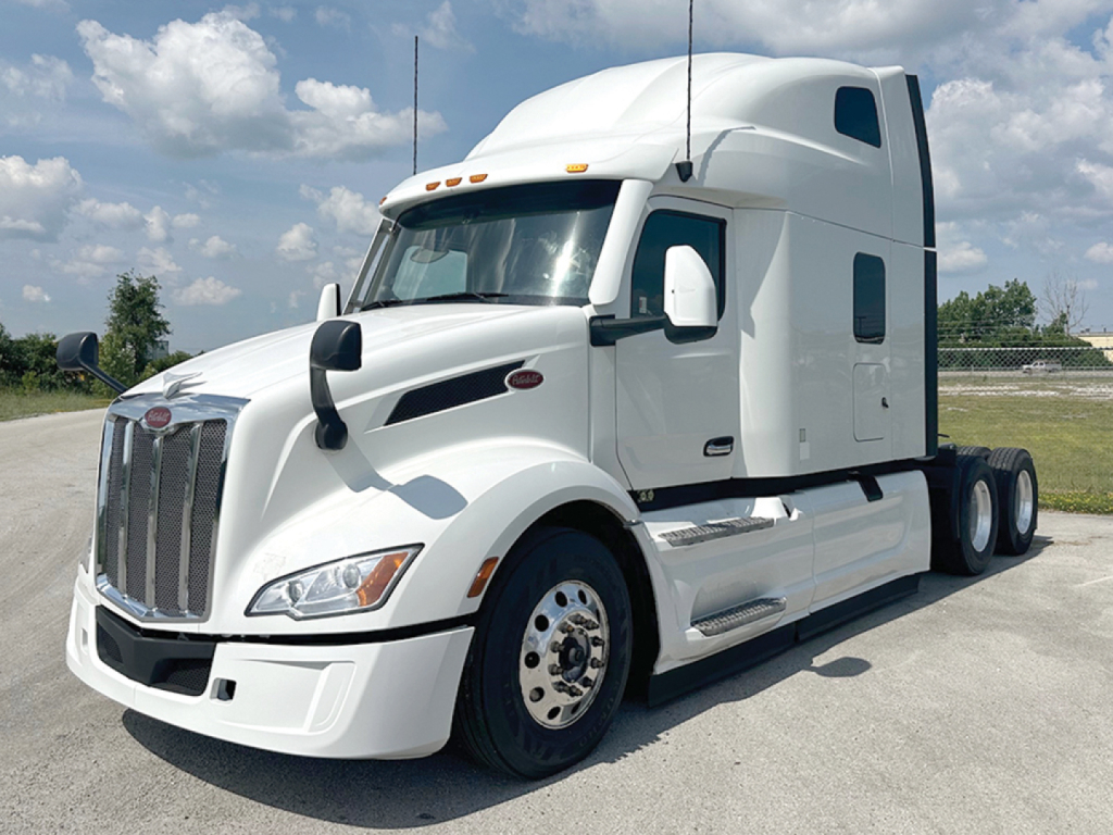 Peterbilt semi-truck tractor in white, front and side view. Text on image includes no visible labels besides truck design.