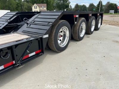 Load King trailer side view showing multiple axles with aluminum wheels and black frame, 9' wide LDH, 24" stretch.