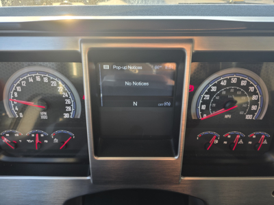 Dashboard view of a 2022 Mack GRANITE dump truck showing instrument gauges and a central infotainment display.