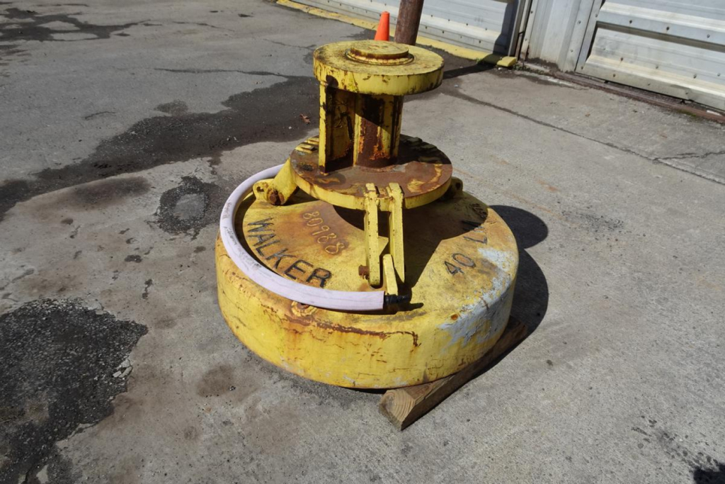 Walker 40LM concrete float or lift device, yellow painted, mounted on a circular base with rust and wear marks.