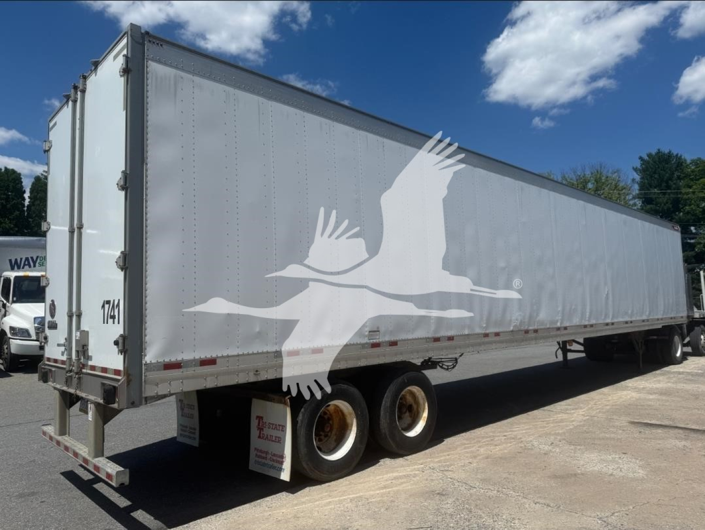 trailer showing Great Dane van trailer with tandem axles and white body; visible stock tag and rear doors, crane line shows 7141