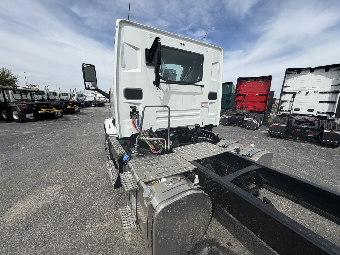 Rear view of a white Mack AN64T daycab truck tractor showing fuel tanks, chassis, and rear cab with wiring harnesses visible.