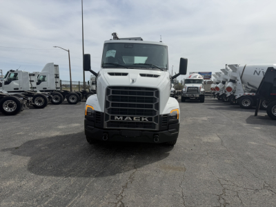 Front view of a white 2027 Mack AN64T conventional daycab truck in a lot, with black grille, large bumper, and side mirrors visible.
