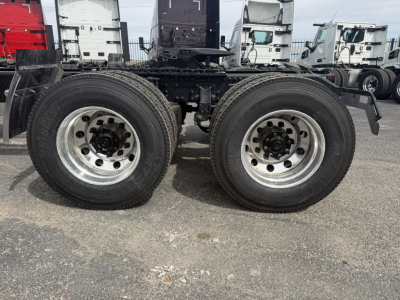 Twin rear axles of a Mack AN64T truck chassis showing dual wheels and suspension components.