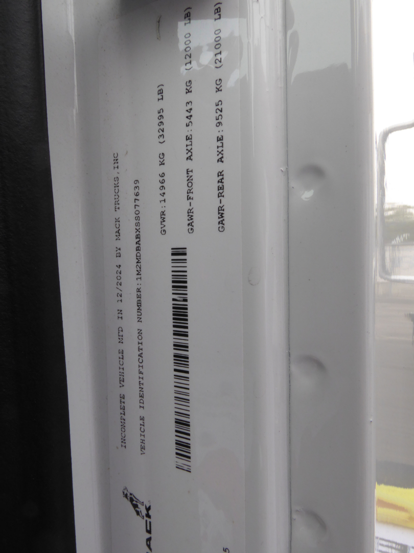 Trucks label showing VIN and stock information for a 2025 Mack MD7 grapple truck. Text includes VIN 1M2MDBABXSS077639 and Stock 68119 with category Grapple and new/used status.