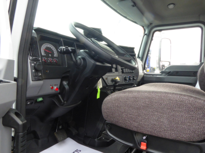 Interior of 2025 Mack MD7 cab showing steering wheel, dashboard gauges, and driver seat.
