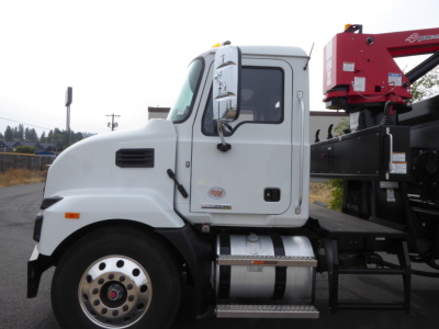 Mack MD7 cab and chassis with mounted grapple crane on the rear; side view shows fuel tank, steps, and door label.