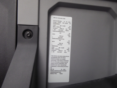 Vehicle data label on 2025 Mack MD7 truck cab area showing specifications and VIN label near latch.