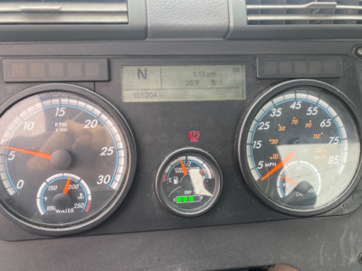 Dashboard of a Freightliner Cascadia 113 showing RPM gauge, speedometer, DEF gauge, and digital display with N gear, time, and temperature.
