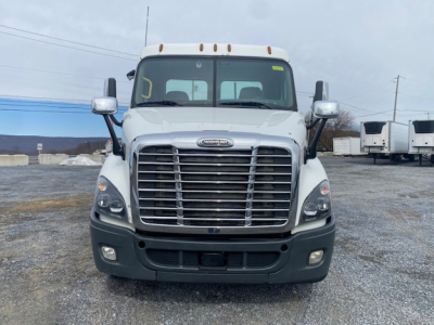 Freightliner Cascadia 113 front view showing chrome grille and bumper, headlights, windshield with mirrors.