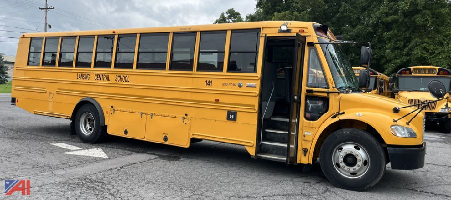 School bus exterior showing open front door, yellow color, ‘LAGG? CENTRAL SCHOOL’ lettering and bus number on side, Freightliner Thomas B2B-C2 style.