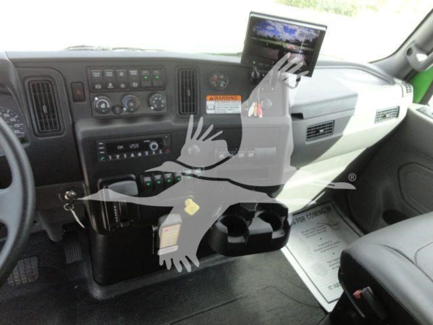 Dashboard of a new International MV truck showing the instrument panel, climate controls, center console, and a mounted tablet display.