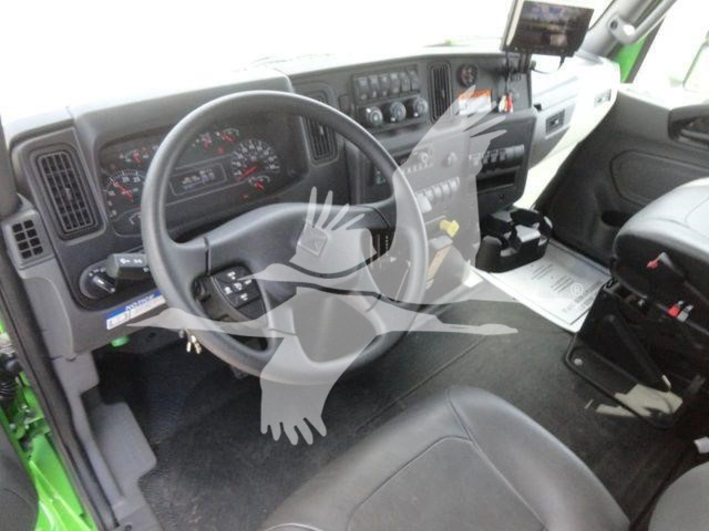 Interior of new 2027 International MV rollback truck showing steering wheel, instrument cluster, center console, and driver seat.