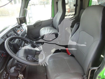 Interior of a cab showing steering wheel, dashboard, and driver seat in a new International MV truck.