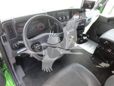 Interior of new 2027 International MV rollback truck showing steering wheel, instrument cluster, center console, and driver seat.
