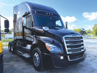 Truck cab of a 2019 Freightliner Cascadia126 sleeper tractor in black, front grille and headlights visible, with chrome mirrors and aerodynamic design.