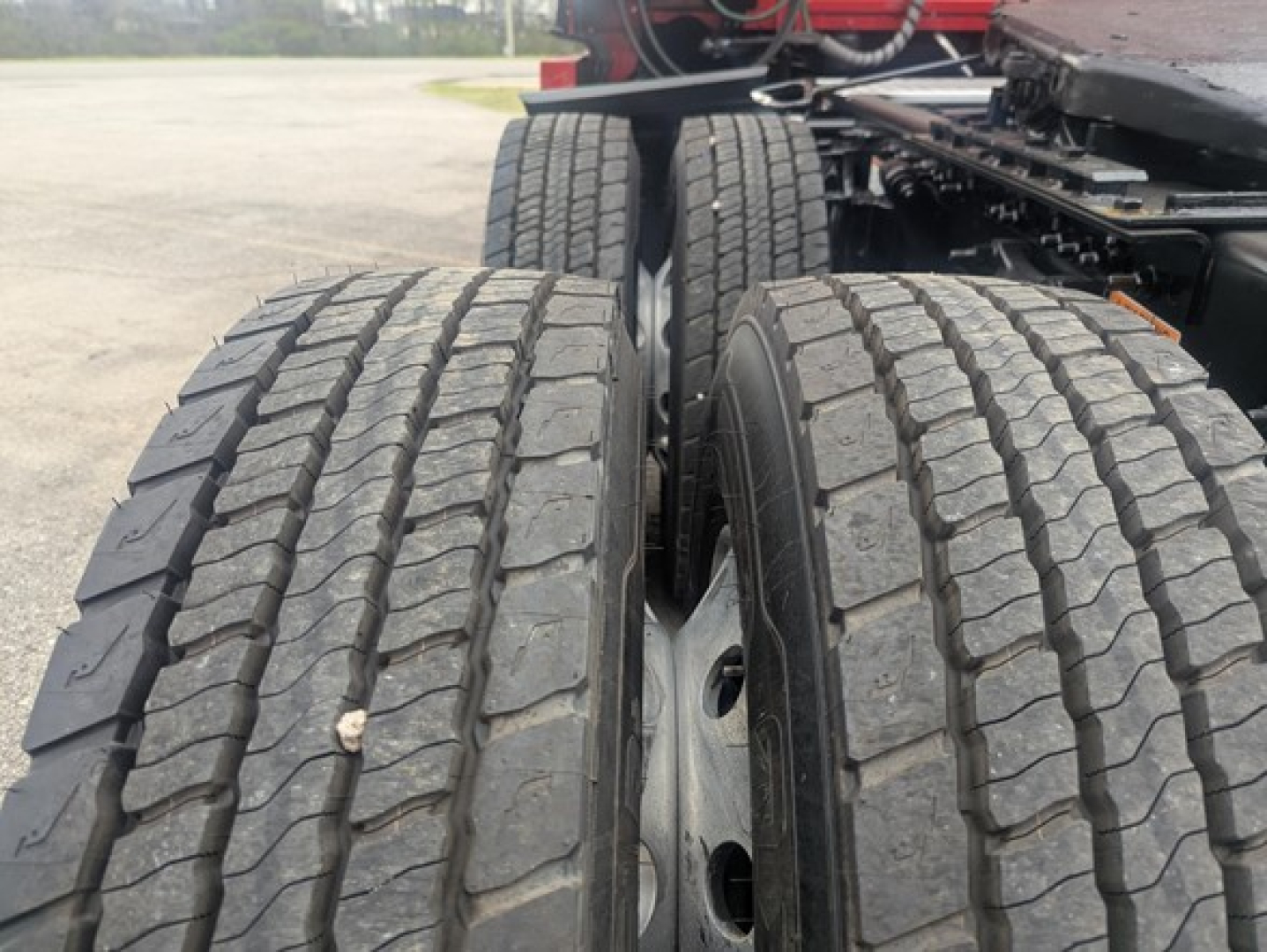Freightliner Cascadia 126 truck rear dual tires and chassis showing tread details.