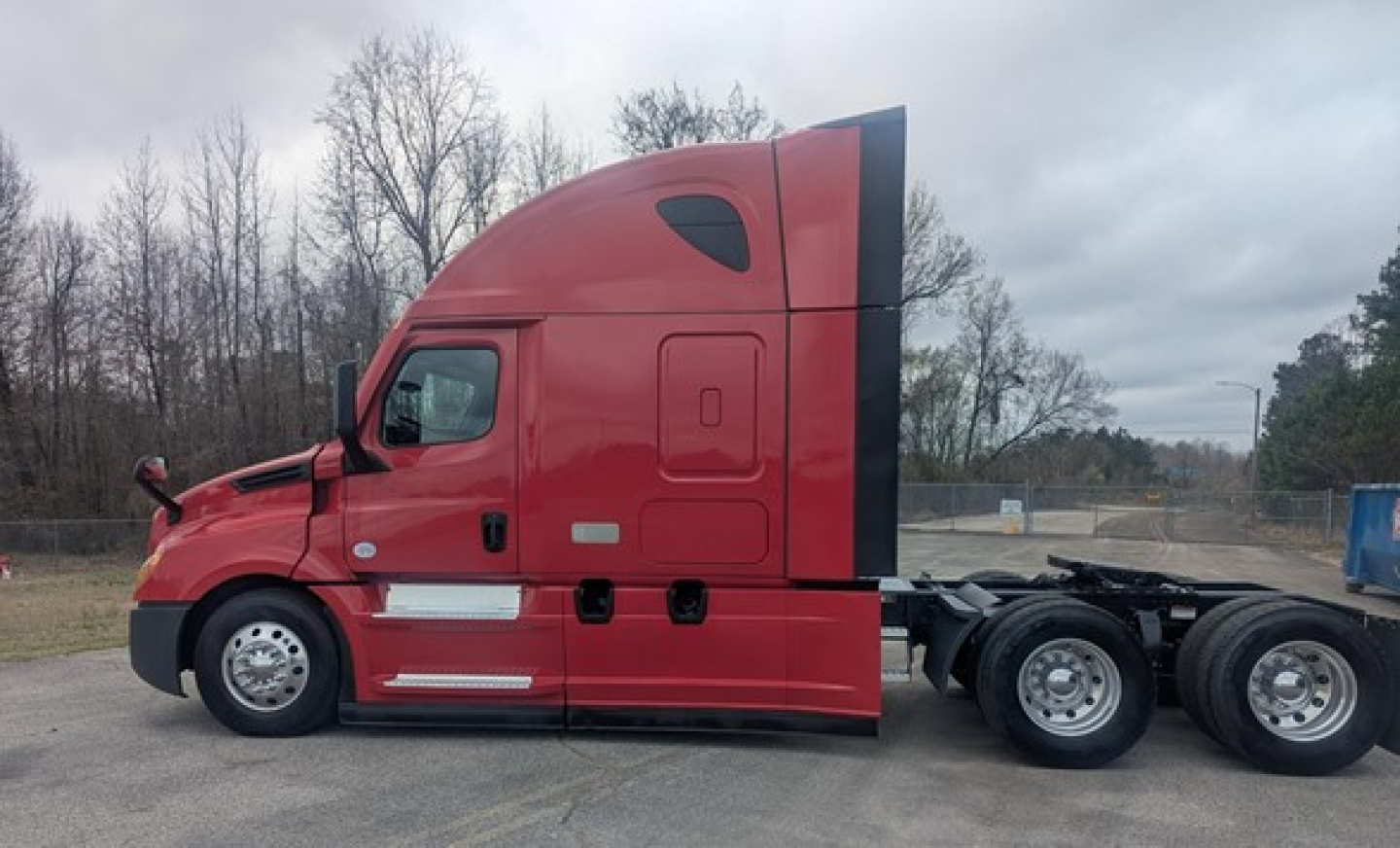 Freightliner Cascadia 126 truck side view showing red cab and chassis with Sleeper configuration.