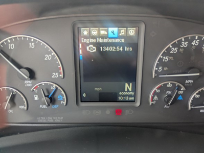 Dashboard of a 2022 Freightliner Cascadia 126 showing center monitor with 'Engine Maintenance' and hours 13402:54, gear indicator N, economy mode, RPM gauge, speedometer, and fuel/DEF gauges.