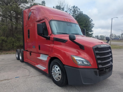 Freightliner Cascadia 126 conventional sleeper truck in red, front-left view, with dual rear axles and black grille