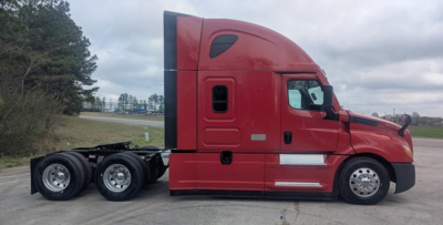 Freightliner Cascadia 126 tractor in red, side view showing sleeper cab, dual rear axles, chrome fuel tanks, and aerodynamic side fairings.
