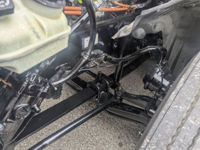 Freightliner Cascadia 126 undercarriage showing front axle steering linkage and suspension components.