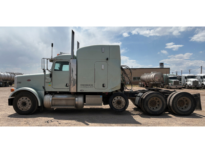 Peterbilt 378 UltraCab truck side view showing sleeper cab and rear axles.