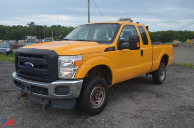 2015 Ford F-250 Super Duty pickup truck with long dual rear wheel? Actually shown is a bright yellow crew cab 4x4 pickup with extended cab. Front grille black, Ford emblem, bumper gray. Text not visible.