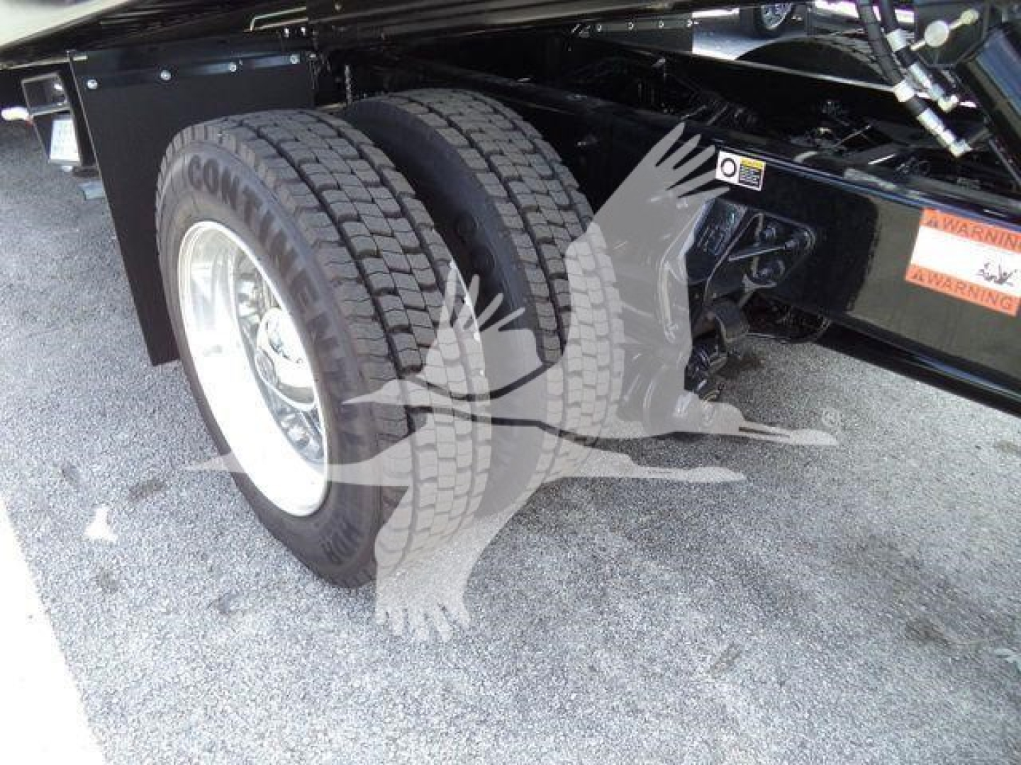 Kenworth T280 chassis rear wheels and dual tires visible under truck frame showing suspension and wheels.