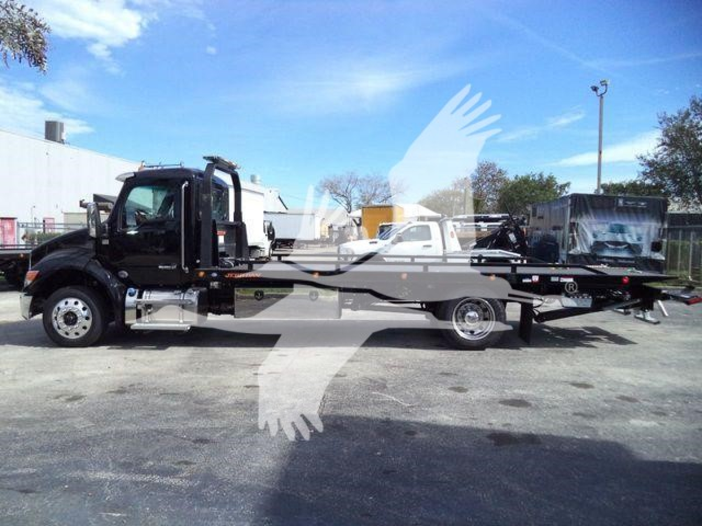 2025 Kenworth T280 rollback tow truck side view with extended flatbed and black cab; text on image includes stock number KWT280XLP22 and category/type labels visible in listing context.