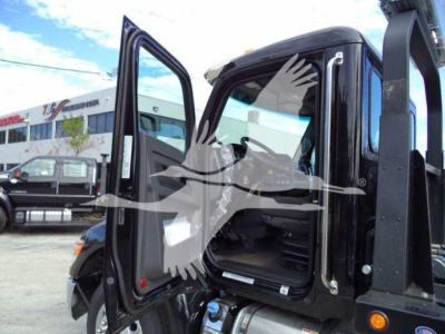Kenworth T280 cab interior with doors open, showcasing driver seat and entry area for a rollback truck